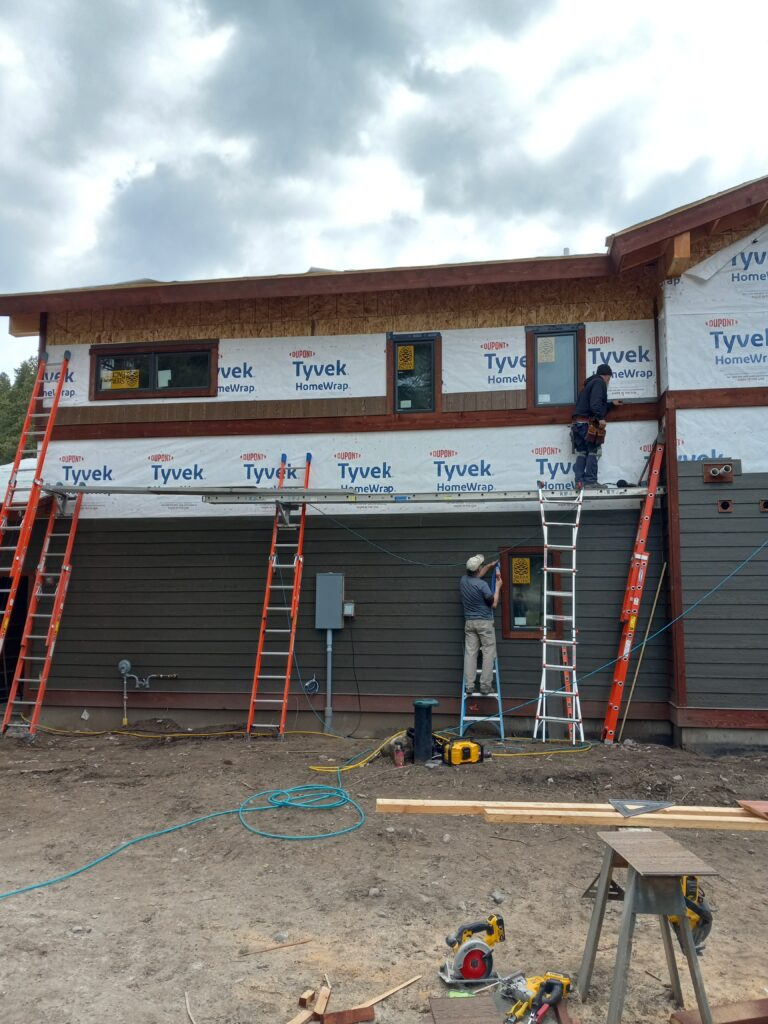 Two men working on the side of a building | Rhino Customs | Columbia Falls, Montana